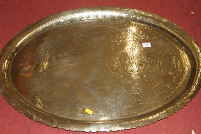 Lot 629 - An Indian polished brass tray, etched with a...