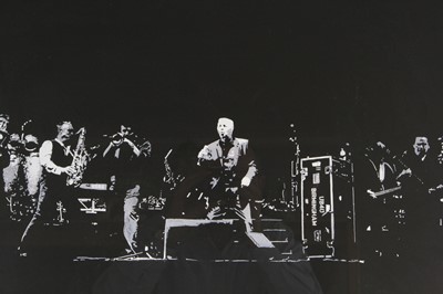 Lot 747 - Brian Travers, (1959-2021), UB40 on stage at...