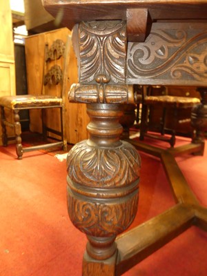 Lot 1475 - A joined and floral relief carved oak dining...