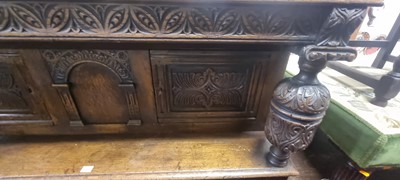 Lot 1476 - A joined and floral relief carved oak court...