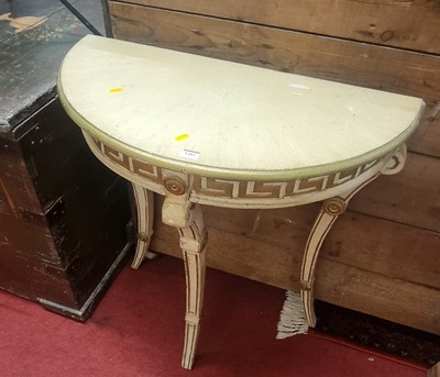 Lot 1482 - A cream painted and gilt decorated demi-lune...