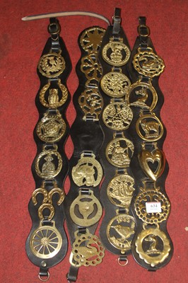 Lot 634 - A collection of horse brasses and straps