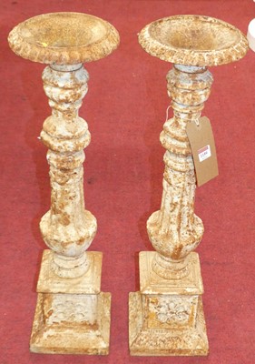 Lot 1159 - A pair of white painted cast iron torcheres, h....