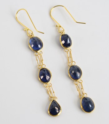Lot 2557 - A pair of yellow metal sapphire drop earrings,...