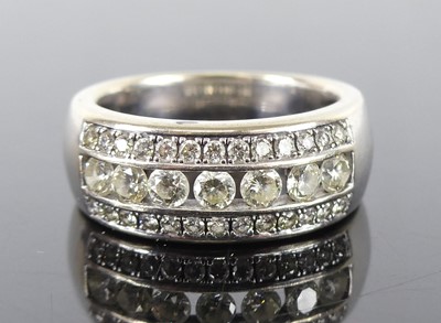 Lot 1289 - A white metal diamond three-row half eternity...