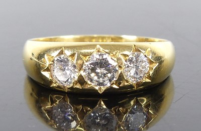 Lot 1291 - An 18ct yellow gold diamond three-stone ring,...