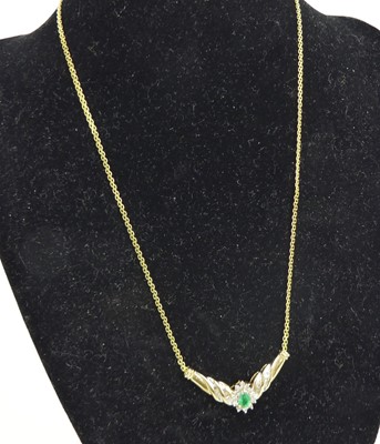 Lot 2613 - A yellow metal, emerald and diamond pear...