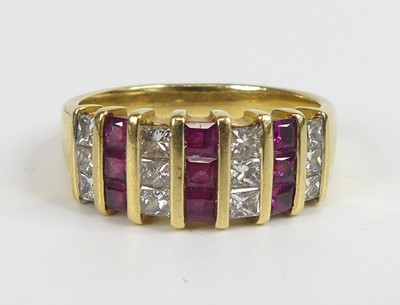 Lot 2573 - A yellow metal, ruby and diamond three-row...