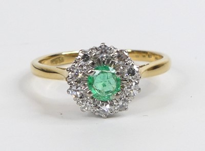 Lot 2632 - A yellow and white metal, emerald and diamond...