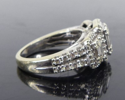 Lot 2670 - A 14ct white gold diamond triple cluster ring,...