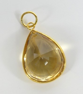 Lot 2674 - A yellow metal citrine pendant, having a pear...