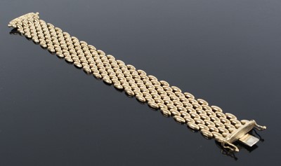 Lot 1243 - A 9ct yellow gold five-row brick link bracelet,...