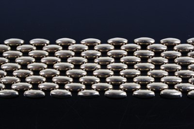 Lot 1243 - A 9ct yellow gold five-row brick link bracelet,...