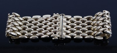 Lot 1243 - A 9ct yellow gold five-row brick link bracelet,...