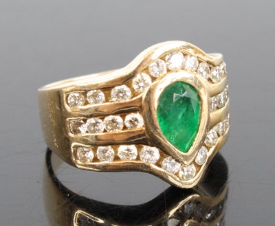 Lot 2711 - A 14ct yellow gold emerald and diamond dress...