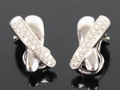 Lot 1298 - A pair of 18ct white gold diamond two-strand...