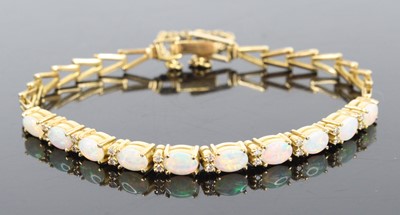Lot 1244 - An 18ct yellow gold opal and diamond bracelet,...