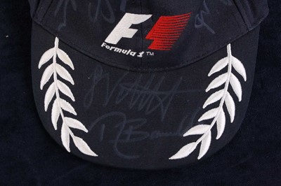 Lot 840 - A Formula 1 peaked cap signed by twelve of the...