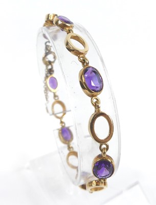 Lot 2635 - A 9ct yellow gold amethyst bracelet, featuring...