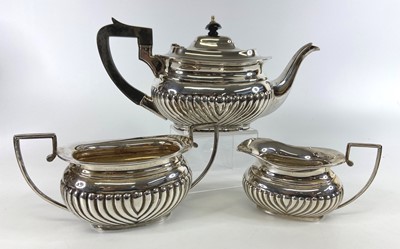 Lot 1207 - A George V silver three-piece matched tea set,...
