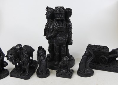 Lot 86 - A black resin figure group of four miners,...