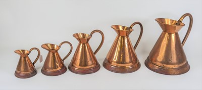 Lot 146 - A graduated set of five copper jugs, largest...