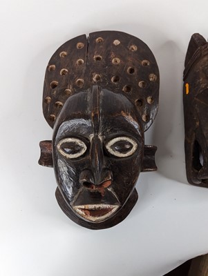 Lot 176 - An African carved hardwood tribal mask, h.48cm;...