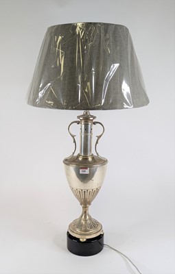 Lot 168 - A silvered metal table lamp in the form of an...