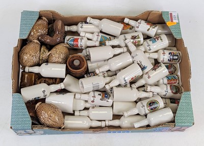 Lot 223 - A collection of crested ware miniature bottles,...