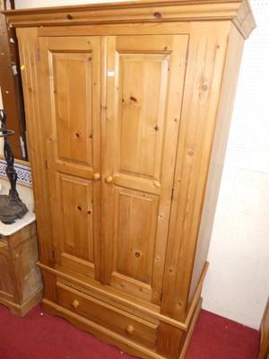 Lot 1156 - A modern pine double door wardrobe, having...