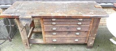 Lot 1174 - An early 20th century pine work bench, having...