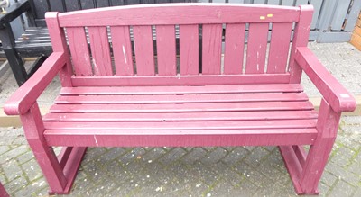 Lot 1180 - A burgundy painted slatted wood three-seater...