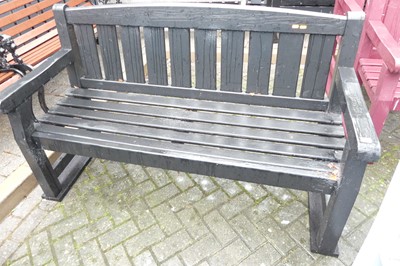 Lot 1182 - A black painted slatted wood three-seater...