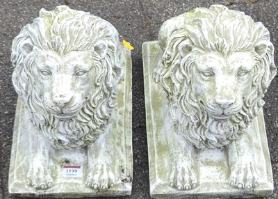 Lot 1199 - A pair of reconstituted recumbent lion garden...