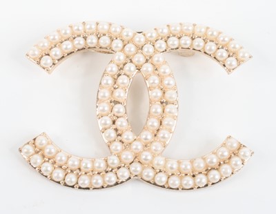 Lot 347 - After Coco Chanel - a gilt metal faux pearl...