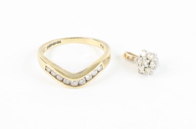 Lot 370 - A modern 9ct gold and diamond set wishbone...