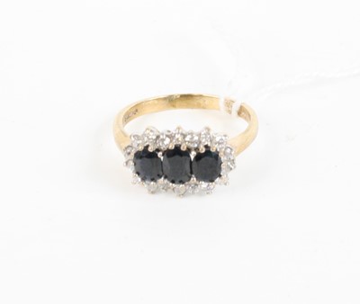 Lot 375 - A 9ct gold, blue and white sapphire dress ring,...