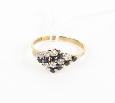 Lot 380 - A 9ct gold, blue and white sapphire lozenge...