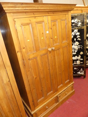 Lot 1222 - A contemporary stained pine double door...