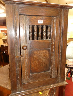 Lot 1250 - A joined oak single door hanging corner cupboard