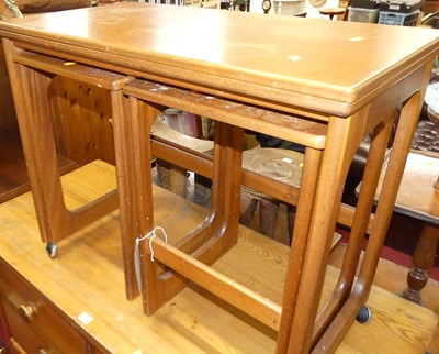 Lot 1277 - A 1970s teak nest of three occasional tables,...