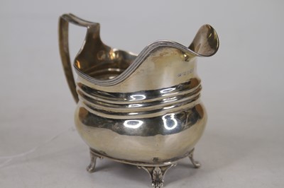 Lot 304 - A George III silver cream jug, on scroll feet,...