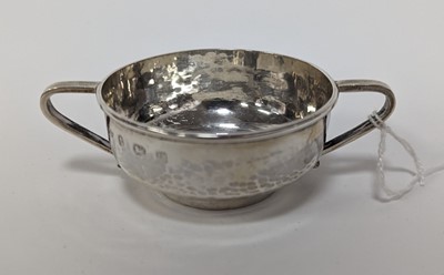 Lot 293 - An Arts & Crafts silver twin handled porringer...