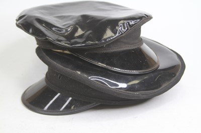 Lot 513 - A black faux leather military style cap,...