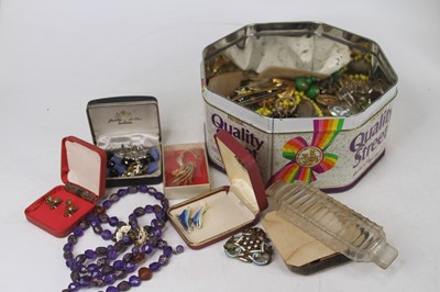 Lot 396 - A tin of assorted costume jewellery to include...