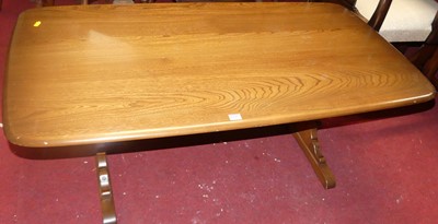 Lot 1342 - An Ercol mid-elm round cornered coffee table,...