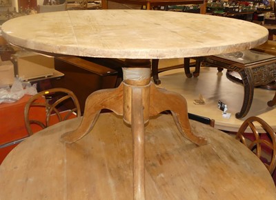 Lot 1343 - A rustic pine circular kitchen table, raised...