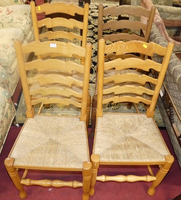 Lot 1372 - A set of four beech ladderback and rush seat...