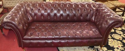 Lot 1374 - A contemporary burgundy leather buttoned three-...