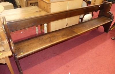 Lot 1397 - A late Victorian oak long church pew, length...